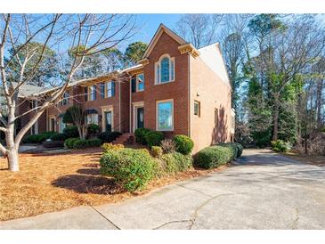 Brick townhouse with a charming front yard and driveway at 1229 Whitlock Ridge Sw Dr, Marietta, GA 30064