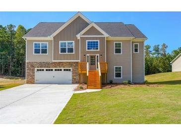 Two-story house with stone accents, wooden stairs, and a large yard at 115 Oakdale Way, Temple, GA 30179