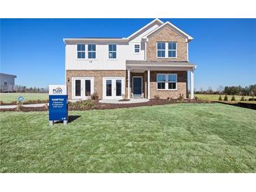 Two-story brick home with white accents and a landscaped lawn at 165 Delilah St, Mcdonough, GA 30252