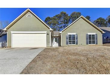 Ranch style home with attached garage and a well-maintained lawn at 175 Paris Dr, Lawrenceville, GA 30043