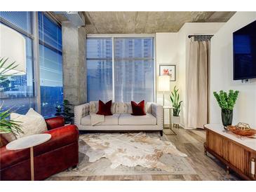 Spacious living room with large windows, comfy seating, and stylish decor at 250 Pharr Ne Rd # 602, Atlanta, GA 30305