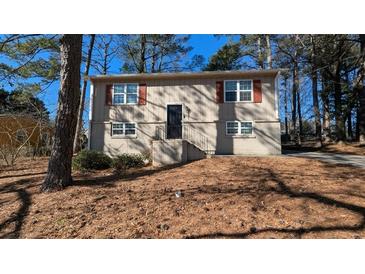 Tan two-story house with red shutters and a small yard at 2531 Ridgecrest Nw Dr, Kennesaw, GA 30152