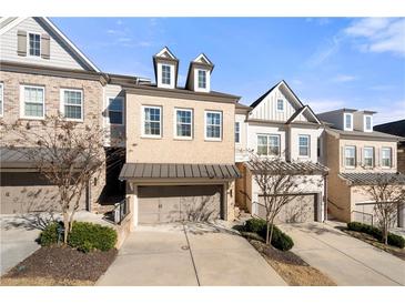 Attractive brick townhome with 2-car garage and landscaped front yard at 3465 Fenton Se Dr, Smyrna, GA 30080