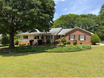 Brick ranch house with large yard and mature trees at 114 Tracy Ln, Mcdonough, GA 30253