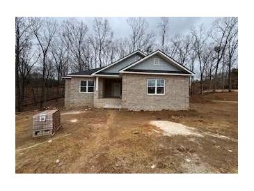 New construction home with brick exterior and a large front yard at 3383 Milan Ct, Douglasville, GA 30135