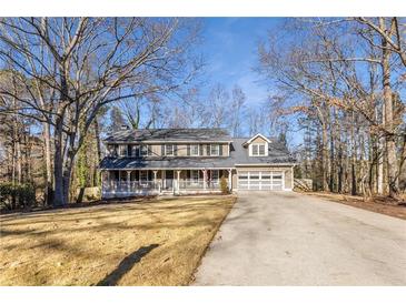 Two-story house with gray siding, white porch, and a two-car garage at 820 Oak Ter, Norcross, GA 30071