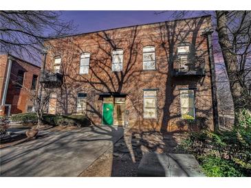 Brick building exterior with green door and balconies at 350 Peters Sw St # 3, Atlanta, GA 30313