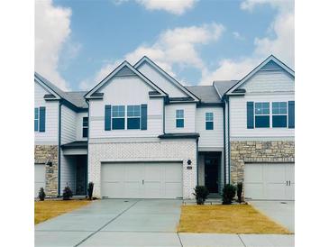 Two-story townhome with gray siding, stone accents, and a two-car garage at 2456 Bayberry St, Acworth, GA 30101