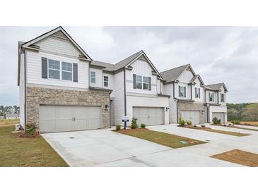 Four townhouses with gray siding, stone accents, and attached garages at 2456 Bayberry St, Acworth, GA 30101