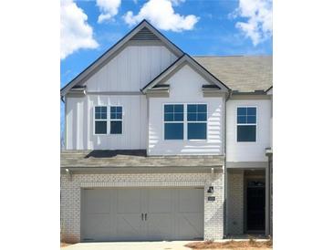 Charming two-story home with white siding, a brick facade, gray accents, and a two-car garage at 2476 Bayberry St, Acworth, GA 30101