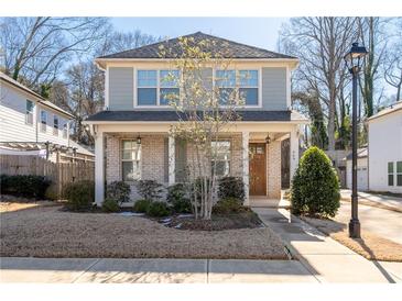 Two-story house with gray siding, brick accents, and a front porch at 969 Rittenhouse Way, Atlanta, GA 30316