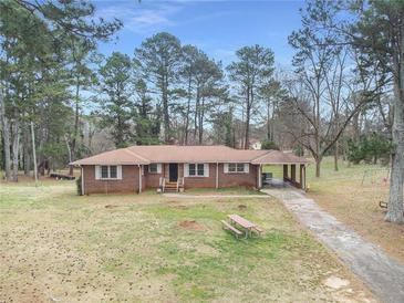 Aerial view of a ranch house with large backyard and surrounding trees at 3496 Wesley Chapel Rd, Decatur, GA 30034