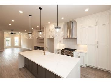 Bright, open kitchen with island, stainless steel appliances, and pendant lighting at 540 Fisher Dr # 46, Alpharetta, GA 30009