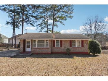 Brick ranch home with a spacious yard at 8554 Taylor Rd, Riverdale, GA 30274