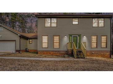 Two-story house with gray siding, green door and wooden steps at 1791 Lake George Dr, Lithia Springs, GA 30122