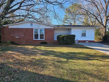 Brick and white ranch house with well-maintained lawn at 1613 Gilston Ct, Decatur, GA 30032