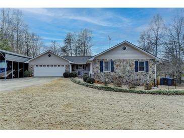 Ranch style home with stone accents and a two-car garage at 208 Hickory Rdg, Cumming, GA 30040