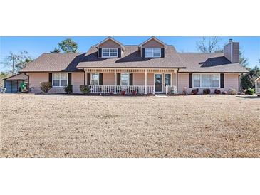 Two-story house with brown roof, porch, and landscaping at 5024 Klondike Rd, Lithonia, GA 30038