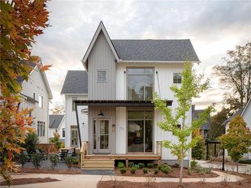 Charming two-story farmhouse with gray and white exterior, and a deck at 731 Belt Se Loop, Atlanta, GA 30316