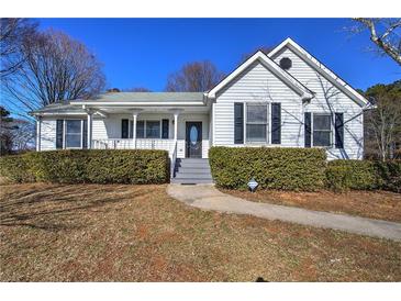 White one-story house with gray roof, landscaping, and walkway at 857 Garner Rd, Rockmart, GA 30153
