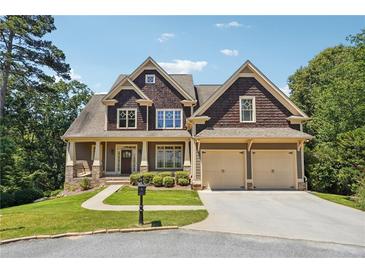 Two-story house with a brown shingle exterior, beige accents, and a three-car garage at 15 Amberly Ln, Cartersville, GA 30121