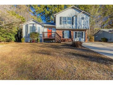 Two-story house with a red door and brown deck at 2522 Corner Shoals Dr, Decatur, GA 30034