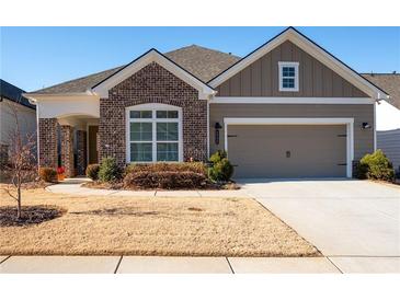 Brick and siding two-story home with attached garage and landscaping at 4980 Pleasantry Nw Way, Acworth, GA 30101