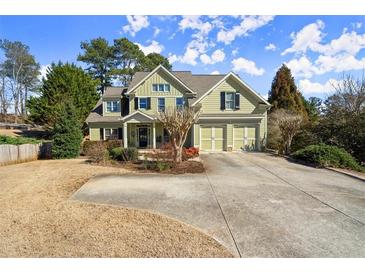 Charming two-story home with a well-manicured front yard and a spacious driveway leading to a two-car garage at 5025 Hidden Ct, Cumming, GA 30040