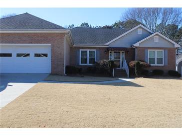 Brick ranch house with attached garage and landscaped lawn at 1419 Gates Mill Walk, Lawrenceville, GA 30045