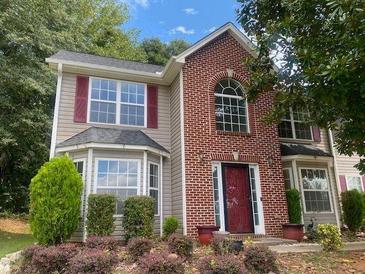 Charming two-story home with brick facade and well-maintained landscaping at 2080 Winding Crossing Trl, Fairburn, GA 30213