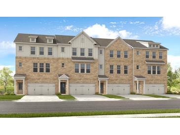 Three-story townhouses with brick and siding exteriors, attached garages, and landscaping at 2829 Rosehall Way, Lawrenceville, GA 30044