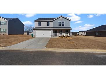 Two-story house with gray siding, stone accents, and a covered porch at 608 Tudor St, Euharlee, GA 30145