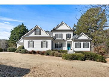 Two-story house with white siding, black shutters, and a teal front door at 164 Castlewood Rd, Tyrone, GA 30290