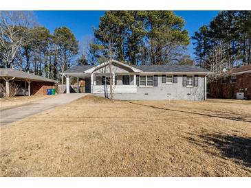Charming ranch home with gray exterior, covered porch, and well-manicured lawn at 3582 Swallow Ln, Decatur, GA 30032