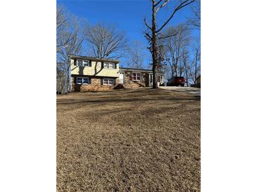 Ranch style home with brick and siding, set on a lot with mature trees at 4139 Chickasaw Trl, Douglasville, GA 30135