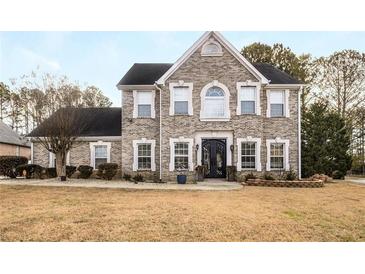 Two-story brick home with a large front yard and landscaping at 3111 Green Gate Se Way, Conyers, GA 30013