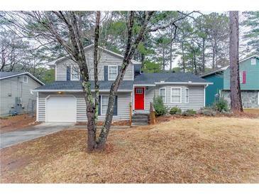 Two-story house with gray siding, red door, and attached garage at 6179 Dana Ct, Lithonia, GA 30058
