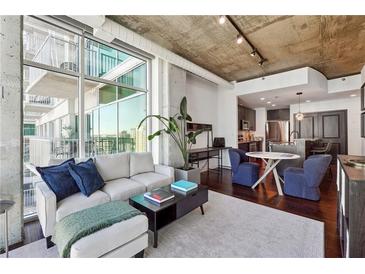 Bright living room with floor-to-ceiling windows and modern decor, perfect for relaxing and entertaining guests at 250 Pharr Rd # 1707, Atlanta, GA 30305
