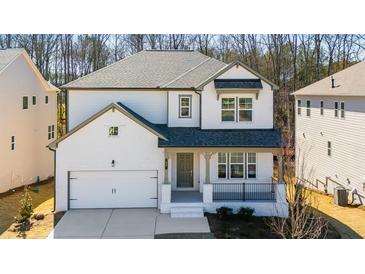 Charming two-story home with white painted brick, covered porch, and an attached two-car garage at 31 Bennett Farm Dr, Loganville, GA 30052