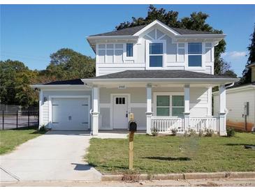 Charming two-story home with light gray siding, a covered front porch, and a single-car garage at 2414 Rose Palm Pl, Atlanta, GA 30315