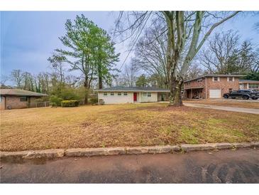 Ranch style home with a red door and spacious yard at 2476 Brentford Pl, Decatur, GA 30032