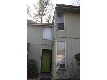 Two story home with a unique olive green door and large picture windows at 2805 Macon Se Dr # 26E, Atlanta, GA 30354