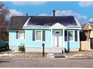 Charming light blue house with a white door and black shutters at 303 Latimer Se St, Marietta, GA 30008