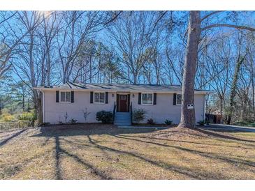 Ranch style home with white brick exterior, updated landscaping, and a spacious yard at 3887 Mcgill Ln, Decatur, GA 30034