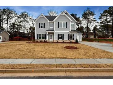 Two-story home with gray siding, a three-car garage, and a large front yard at 1441 Stephens View Dr, Loganville, GA 30052