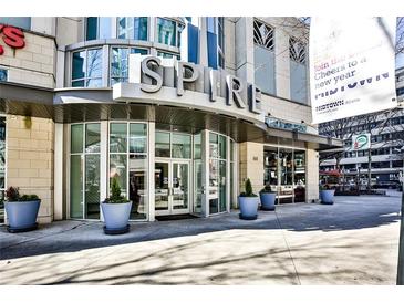 Spire building entrance with modern design and landscaping at 860 Peachtree Ne St # 2506, Atlanta, GA 30308