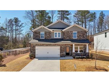 Charming two-story home featuring stone accents, a two-car garage and a well-manicured front lawn at 281 Martin Spring Rd, Lawrenceville, GA 30045