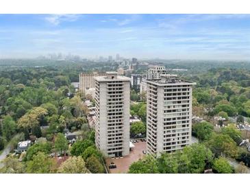 Aerial view of two high-rise buildings with city skyline in the background at 2575 Peachtree Ne Rd # 11D, Atlanta, GA 30305