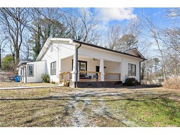 Charming white cottage with a front porch and well-maintained lawn at 3595 South St, Duluth, GA 30096