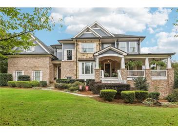 Two-story home with brick and siding exterior, front porch, and landscaping at 3051 Oglethorpe Ne Way, Brookhaven, GA 30319